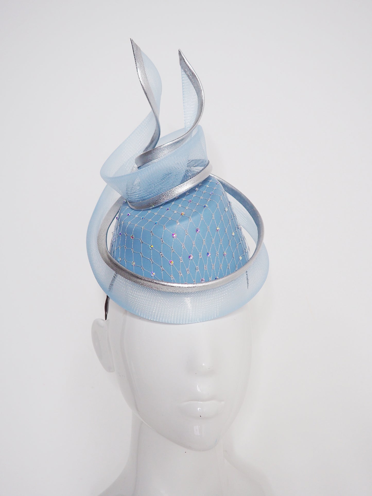 Frozen in time - Blue asymetrical leather base with silver veil and iridescent crystals and a crinoline swirl