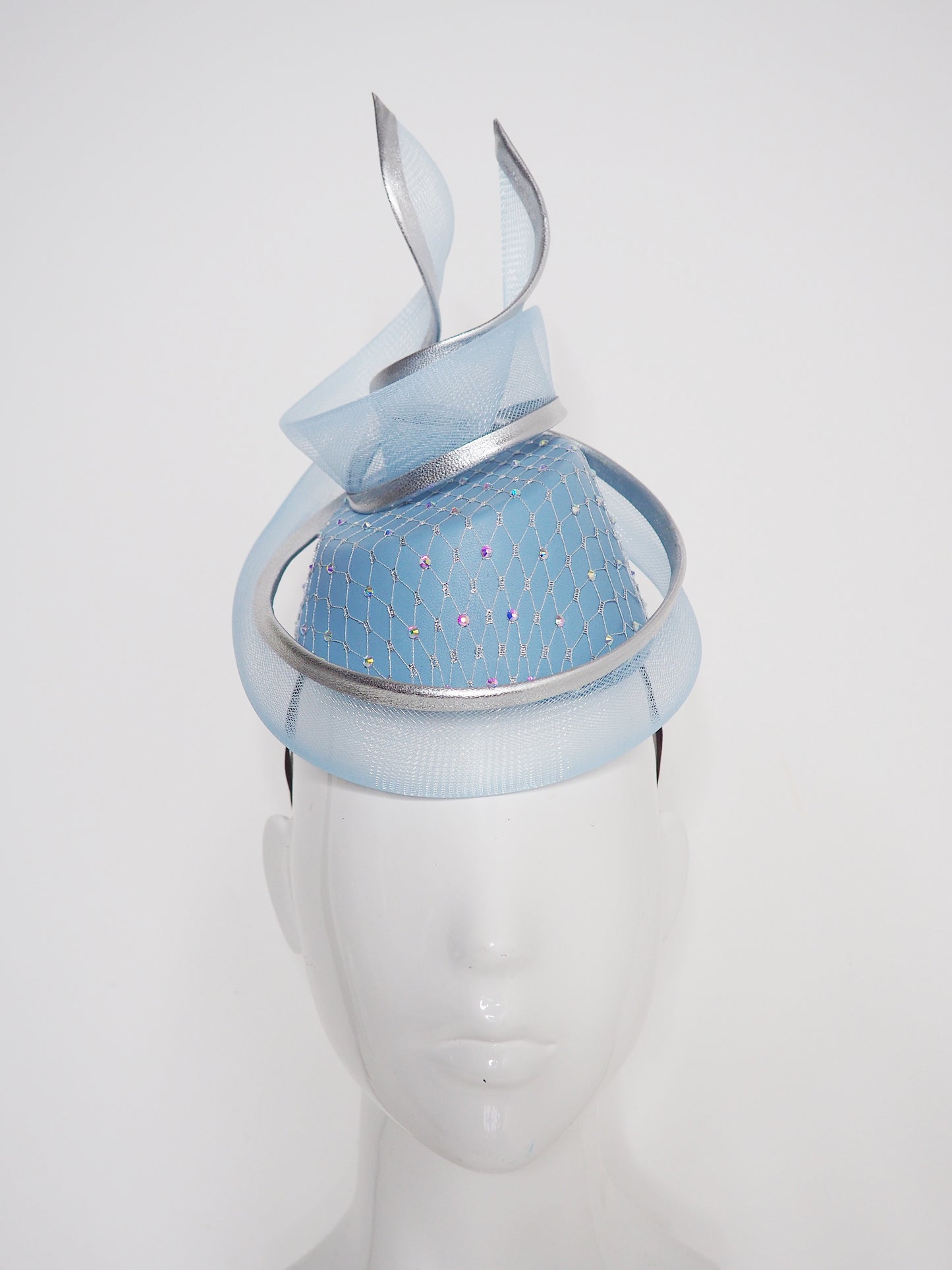 Frozen in time - Blue asymetrical leather base with silver veil and iridescent crystals and a crinoline swirl