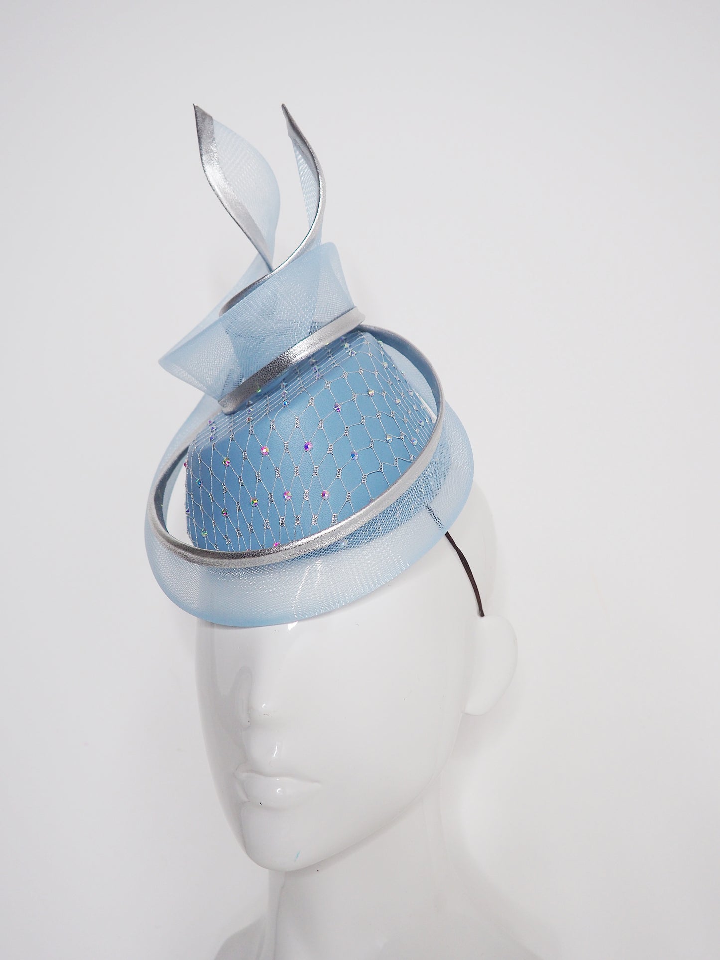 Frozen in time - Blue asymetrical leather base with silver veil and iridescent crystals and a crinoline swirl