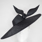 Derby Pose-  Slanted brim parisissal straw with asymmetric crown and wires knot detail