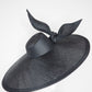 Derby Pose-  Slanted brim parisissal straw with asymmetric crown and wires knot detail