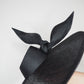 Derby Pose-  Slanted brim parisissal straw with asymmetric crown and wires knot detail