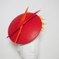 Out of the fire - Red leather percher disc with hyacinth orange diamantés trimmed quills and wired feather spray